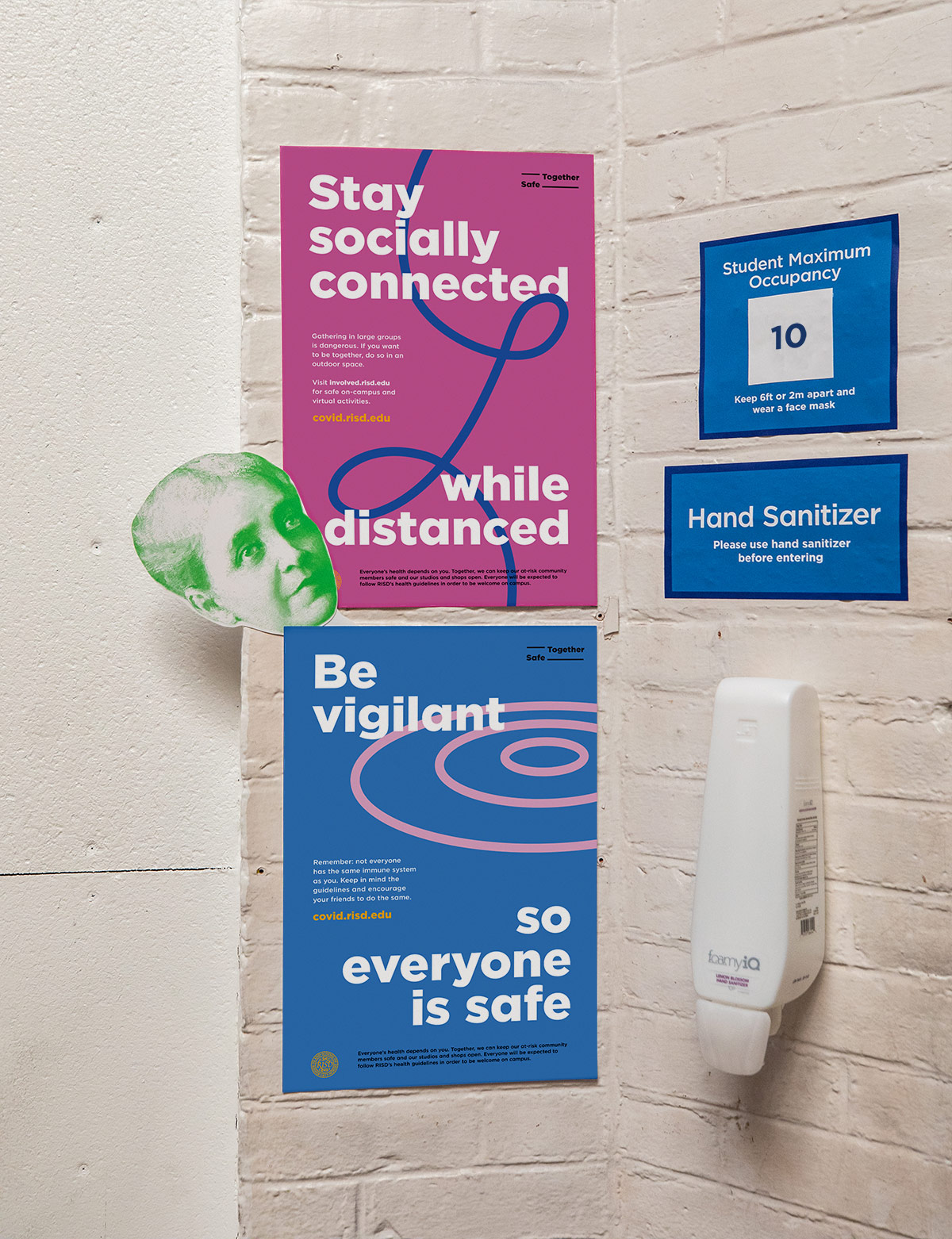 RISD Safe Together posters in a communal area with hand sanitizer