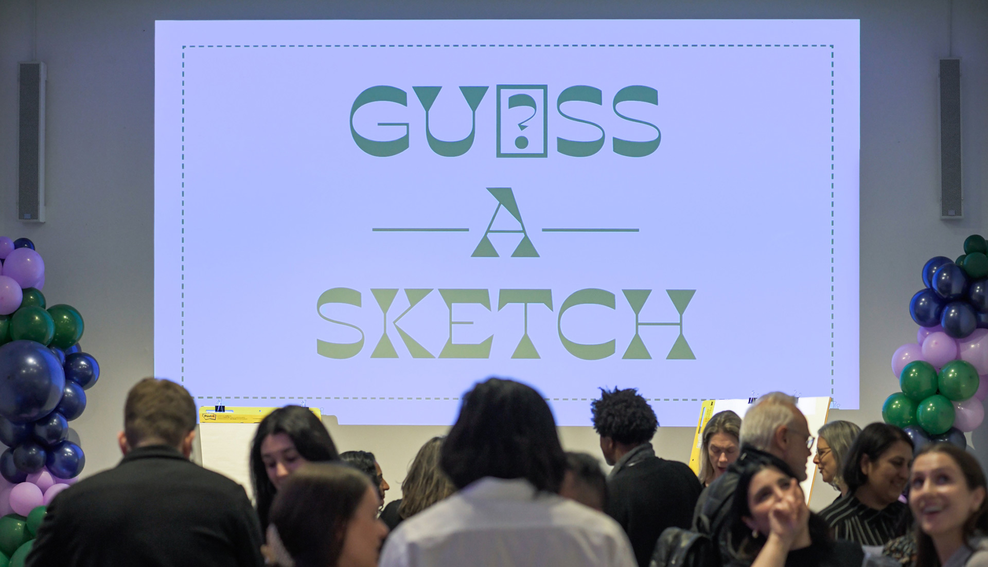 Guess-A-Sketch logo slide projected behind the event.