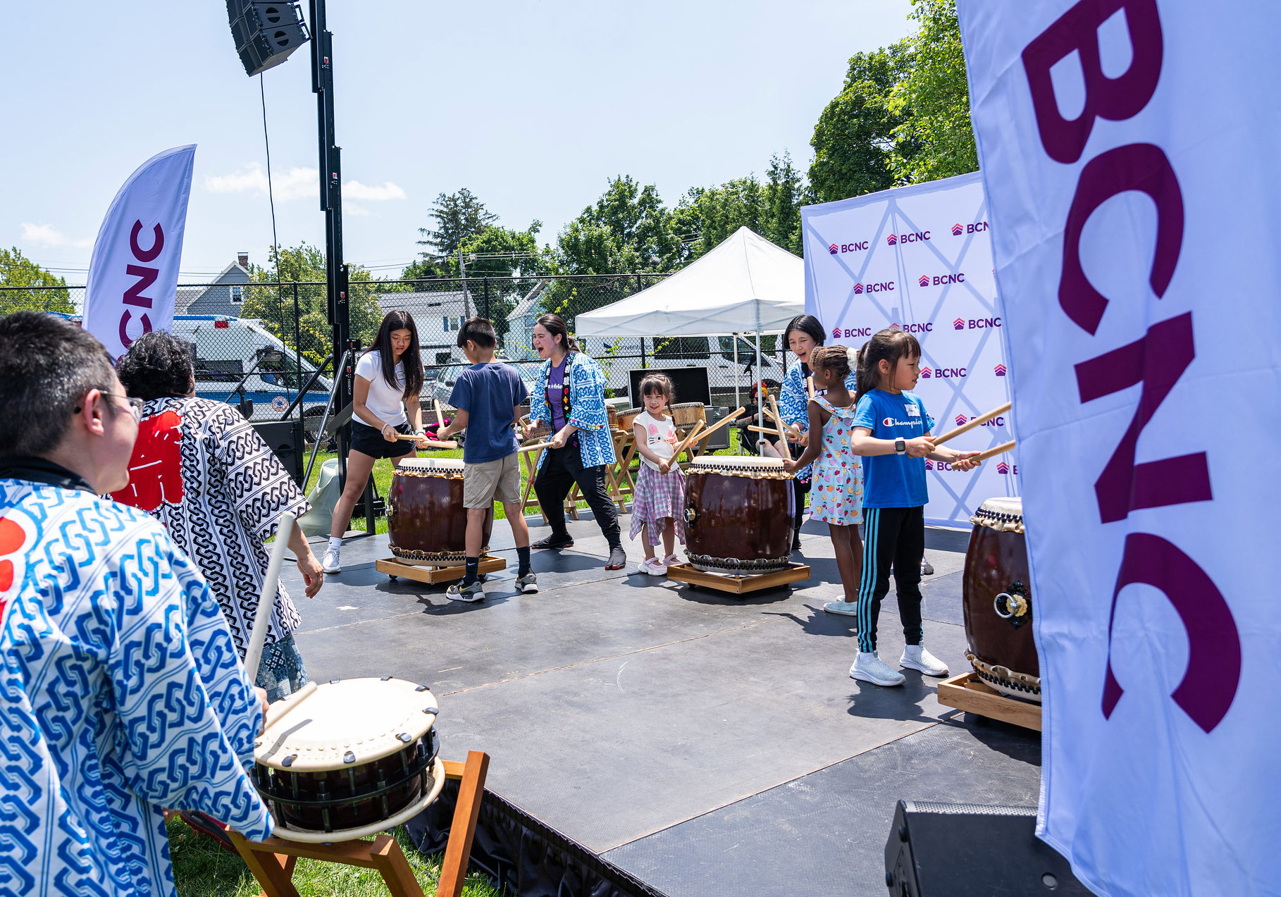 Children drumming on stage at the BCNC Family Fun Fair in Quincy