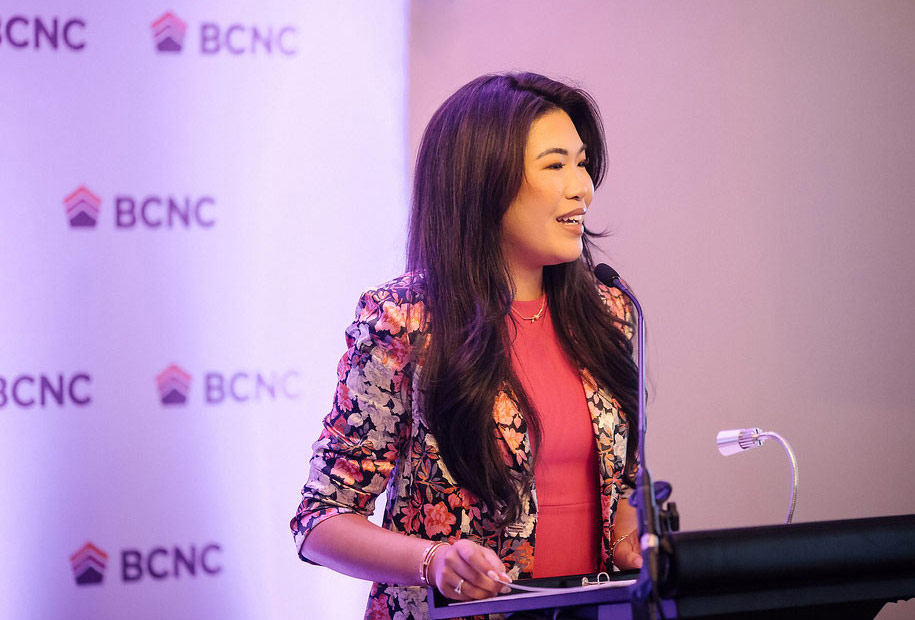 Speaker at BCNC annual gala with step and repeat banner behind
