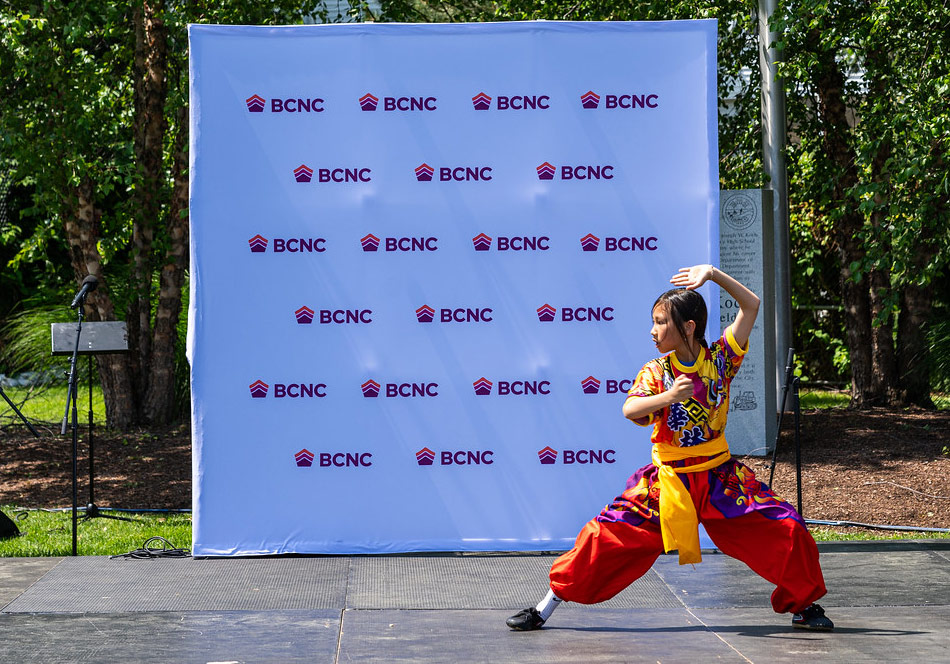 BCNC step and repeat backdrop with performer in front